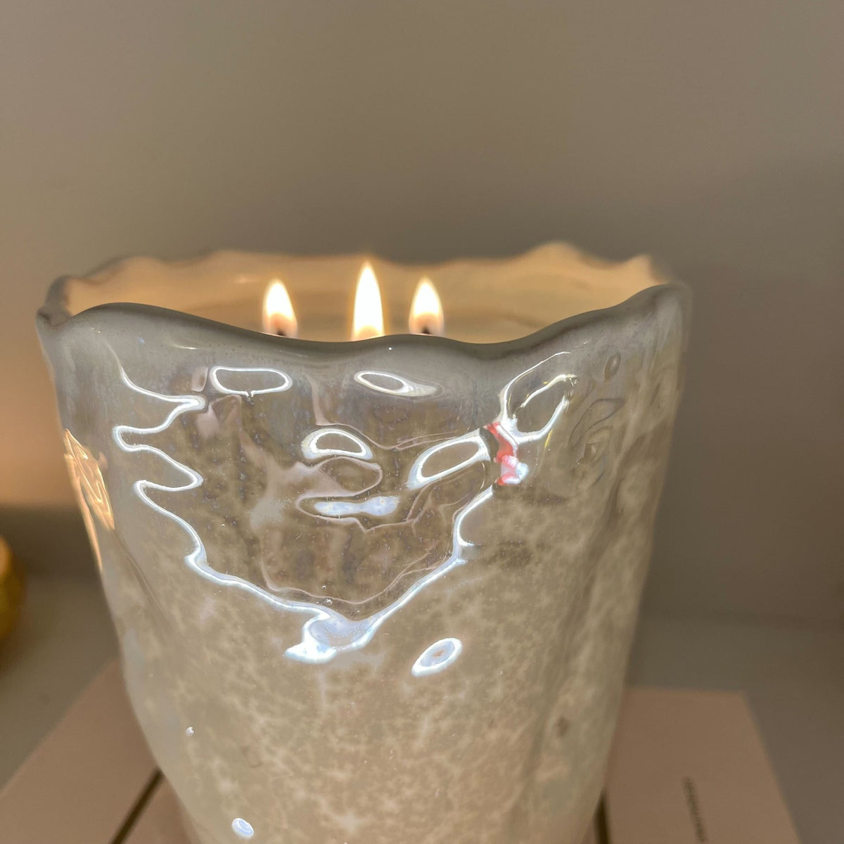 A rippled holder with a pearly sheen
